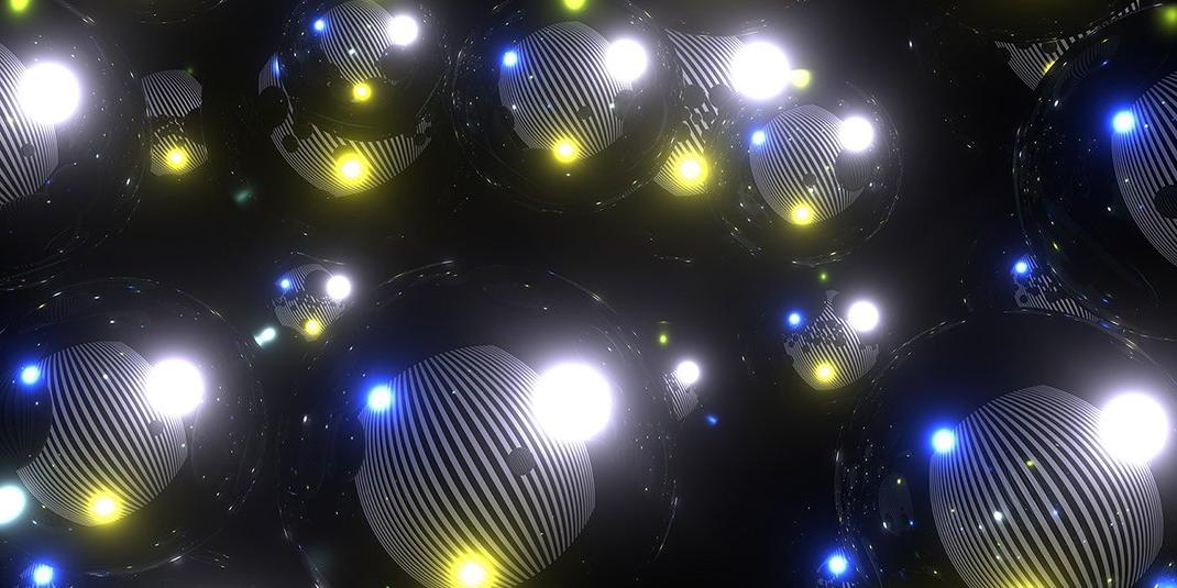 An abstract image with white, blue, and yellow lights against a black background